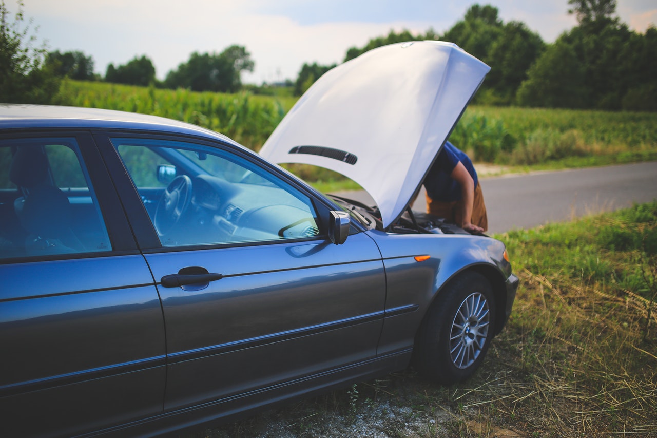 Person trying to restart their car. What to Do When Your Car Wont Start concept image